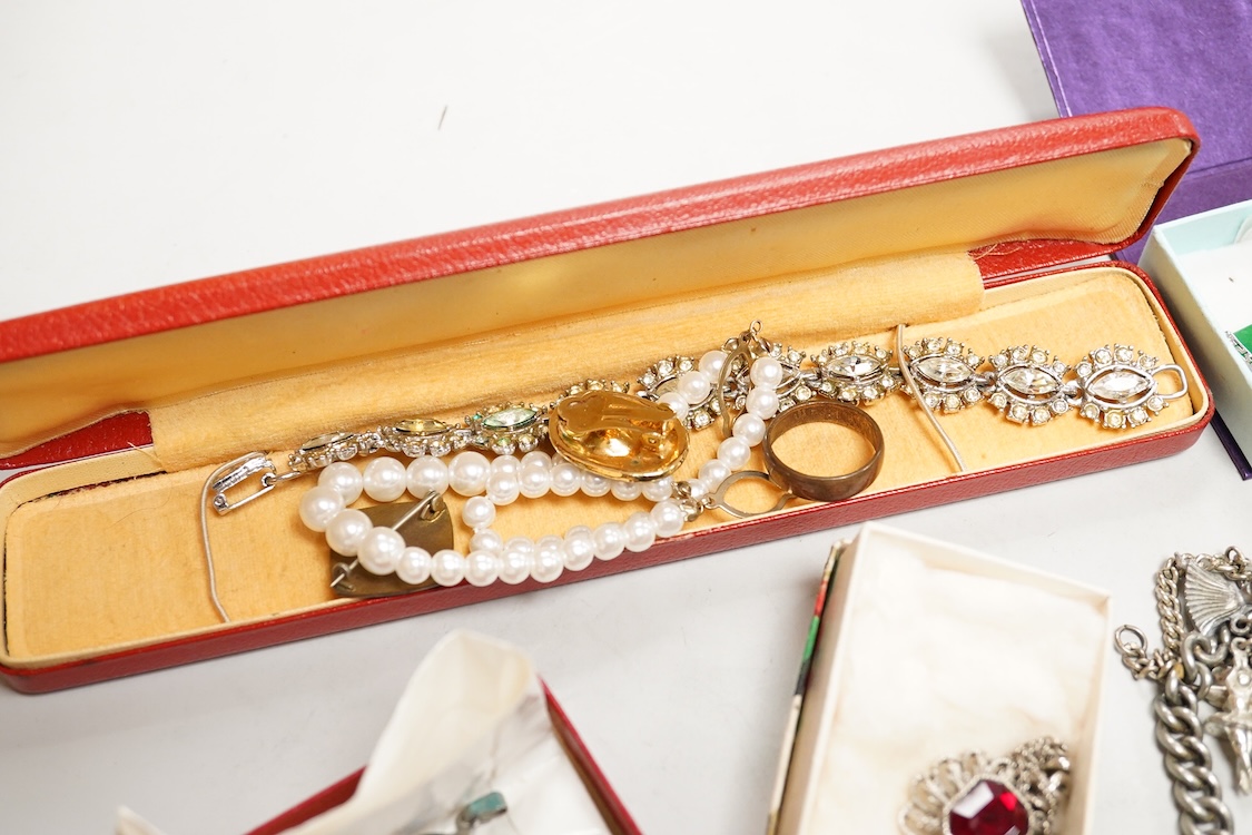 A collection of silver and costume jewellery, including a silver locket, St Christopher ingot pendant and watch chain, and a selection of costume jewels